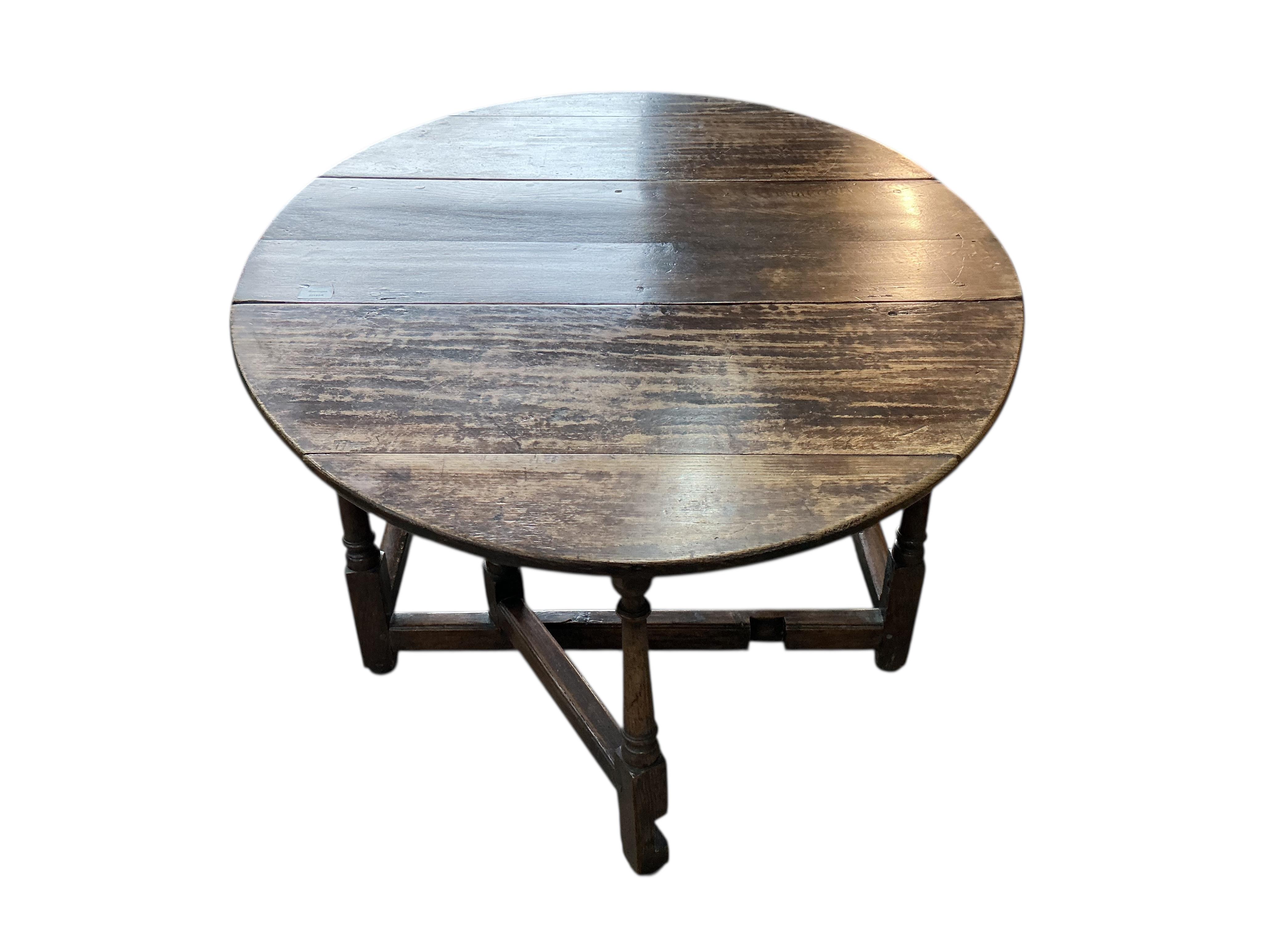 An early 18th century oak gateleg table, width 104cm, depth 47cm, height 69cm